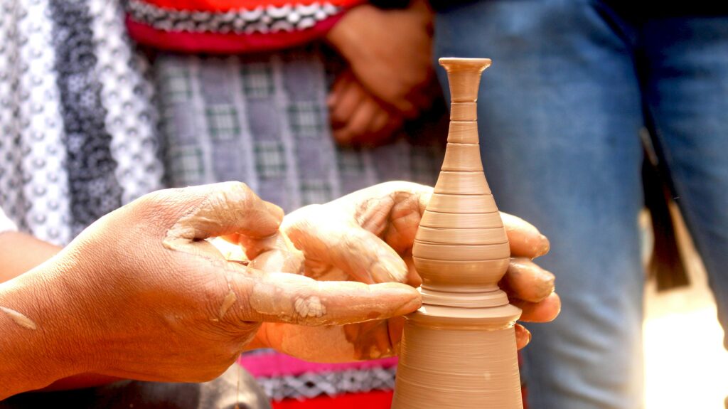 pexels-photo-320577-320577 Close-up of artisan shaping a delicate clay vase with hands, showcasing skill and tradition.