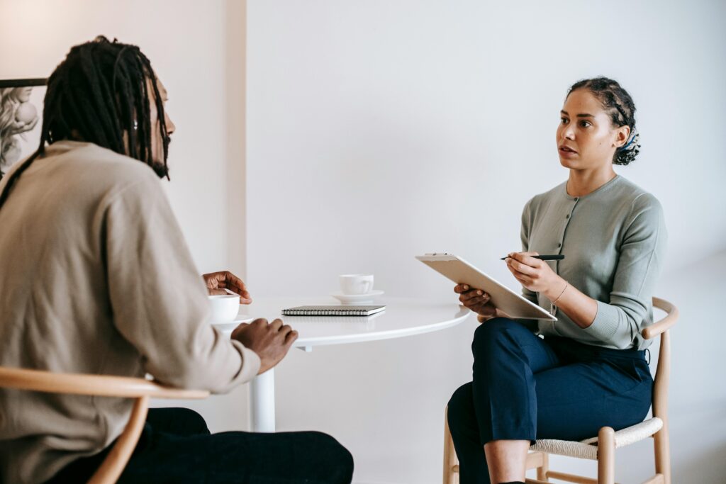 pexels-photo-5699479-5699479 A professional job interview between a man and woman in a modern office setting.